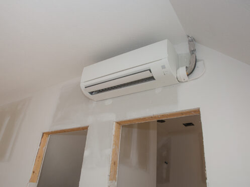 Mini-split ductless air conditioning unit installed in unfinished room in Long Island, NY